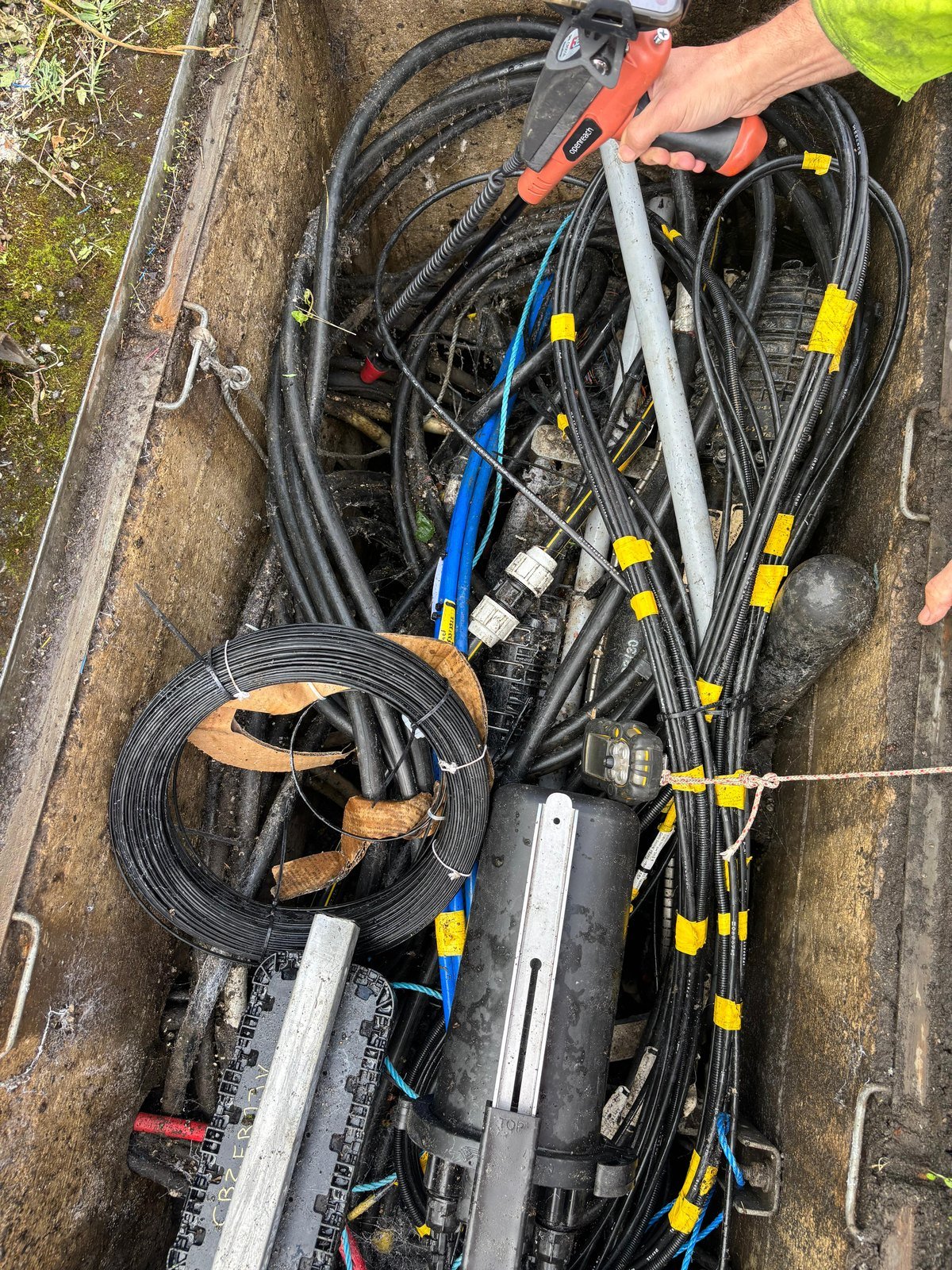 Cable ID receiver and app in use at a street cable chamber